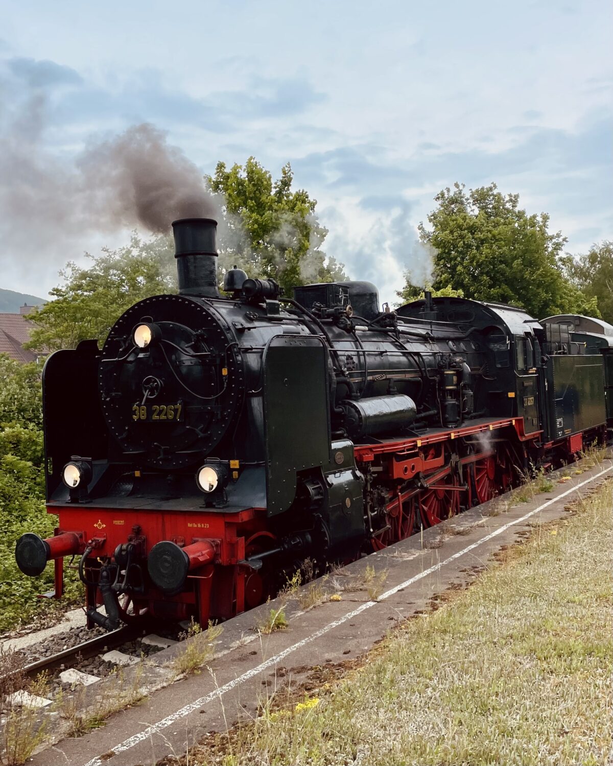 Die Dampflok 382267 in Rinteln. Die Lok qualmt und raucht. Schräg von vorn fotografiert.